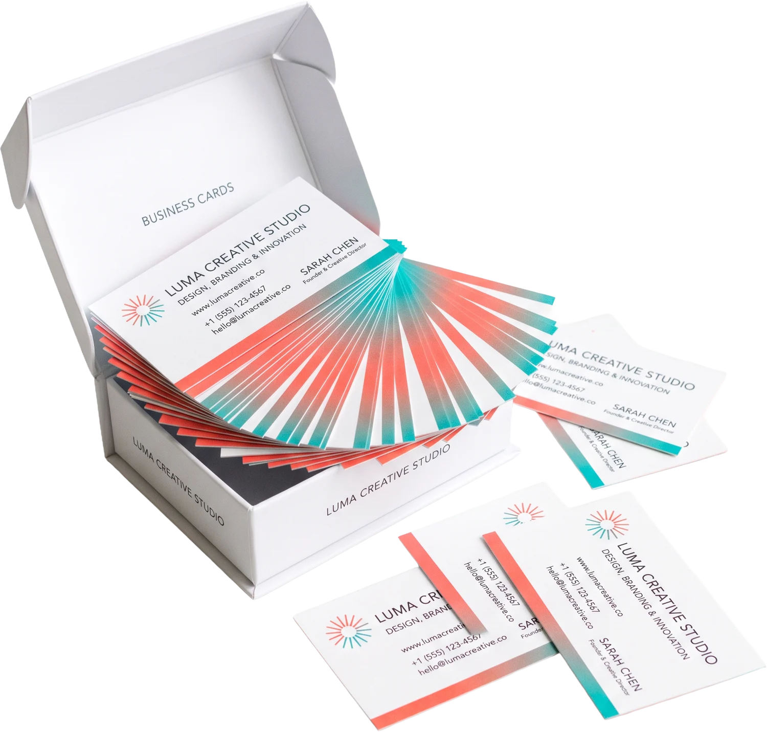 Open box of business cards with cards fanned beside it